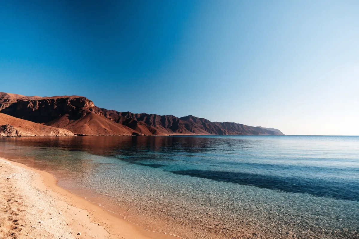 AI-generated illustration: Aqaba-inspired Red Sea shore